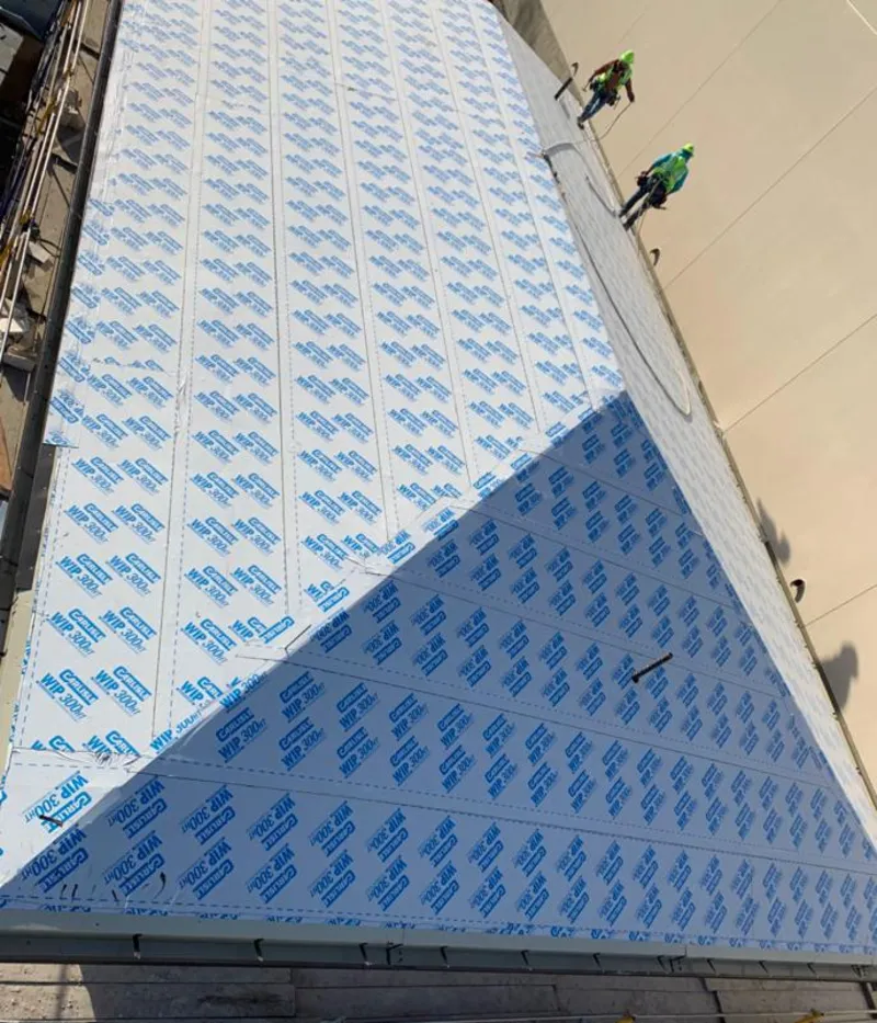 Professional roofers installing underlayment on a metal roof in Palisades Park